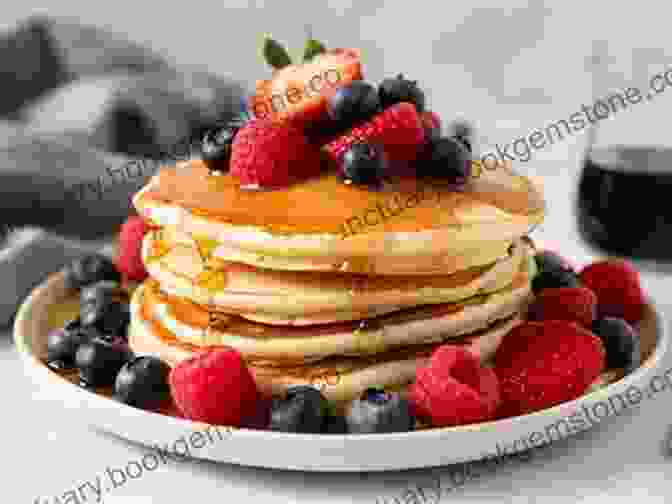 A Stack Of Fluffy Canadian Pancakes Drizzled With Maple Syrup And Garnished With Fresh Berries CANADIAN RECIPES FOR YOU AND YOUR ENTIRE FAMILY